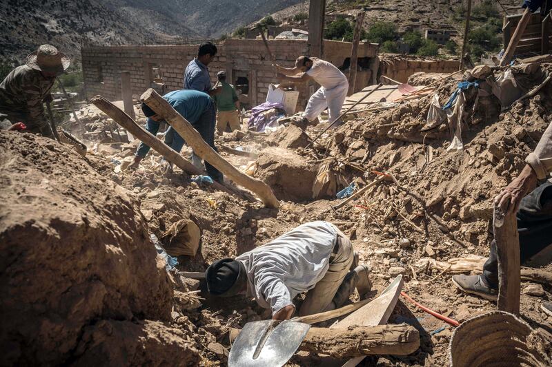 Men dig frantically through the rubble of Mohammed Abrada’s home as they search for his missing daughter in Douar Tnirt, Morocco, on Monday, in the wake of Friday's devastating earthquake. Photograph: Sergey Ponomarev/New York Times
                      