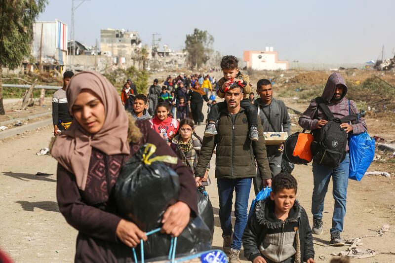 Displaced Palestinians from the northern Gaza Strip pass through an Israeli checkpoint on their way south on Sunday. Photograph: Samar Abu Elouf/New York Times