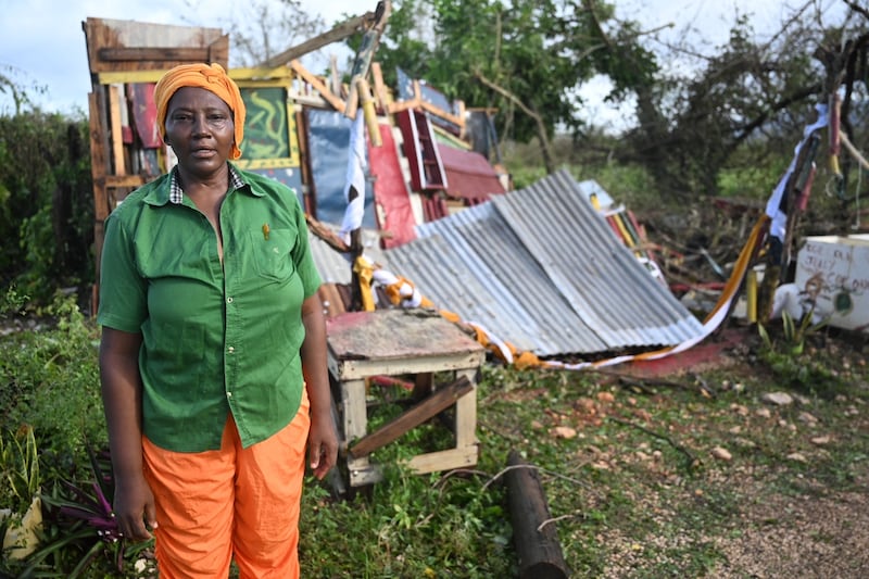Celia Coke stands next to her shop, destroyed after the passage of Hurricane Melissa, in the Wilton district of St Elizabeth, Jamaica on Wednesday. Photograph: Ricardo Makyn/AFP via Getty Images 