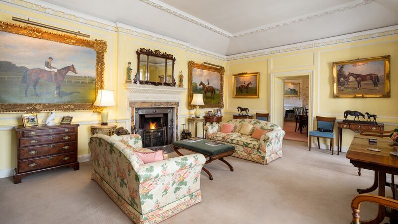 Horse paintings  decorate the walls of the sitting room