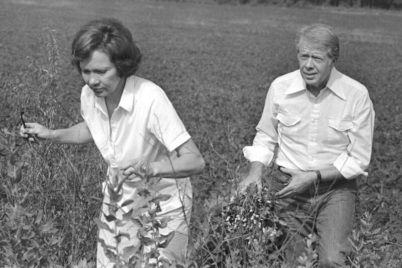 President Jimmy Carter carries a peanut plant as he follows his wife Rosalynn in a field in Webster County, Georgia, in the 1970s. Photograph: Jim Wells/PA