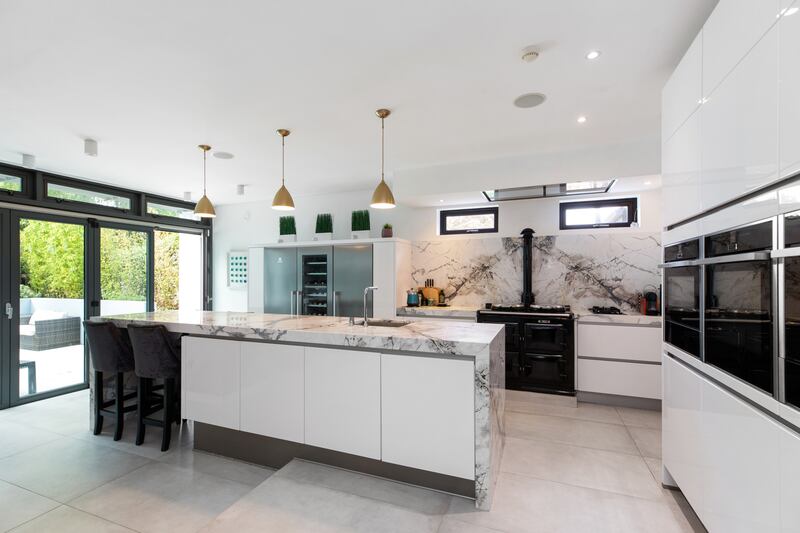 The kitchen is stunning, featuring a Ponte Vecchio marble-clad island