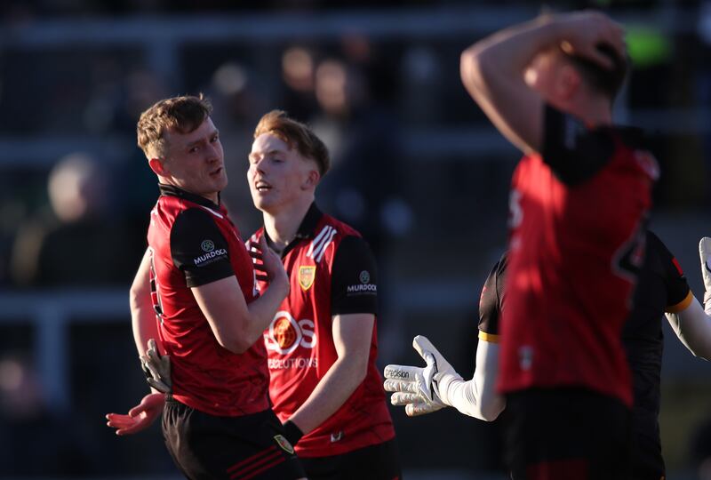 Down’s Liam Kerr, Oisin Savage and Ceilum Doherty react to a missed shot on goal during the Ulster championship game against Antrim at Páirc Esler, Newry. Photograph: Leah Scholes/Inpho