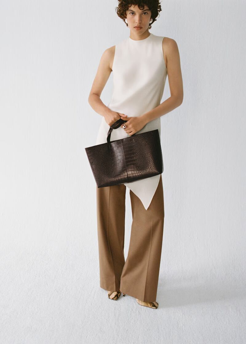 Asymmetrical satin top, €55.99, straight wool-blend suit trousers, €59.99, volume hoop earrings €15.99, animal print high-heeled shoes, €59.99, and shopper bag with double handle, €29.99, from Mango
