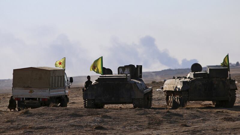 Fighters from the Democratic Forces of Syria stand near their infantry fighting vehicles around the al-Khatoniyah lake area after they took control of it from Islamic State militants, near al Houl town in Hasaka province, Syria on Saturday. Photograph: Reuters