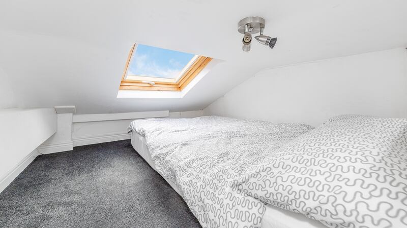 The mezzanine sleep loft is enhanced with a skylight, creating a snug space for a double bed accessed via steps