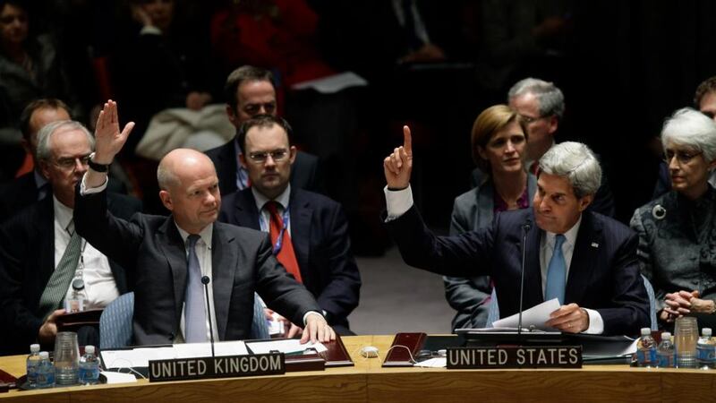 British foreign secretary William Hague and US secretary of state John Kerry vote on a resolution regarding Syria’s chemical weapons programme  at a meeting of the United Nations Security Council  in New York last night. Photograph:  Joshua Lott/Getty Images