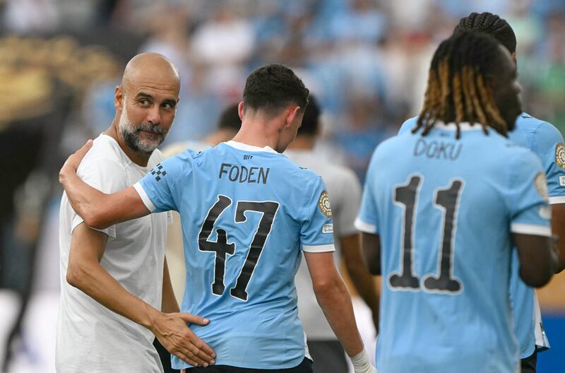 Manchester City's head coach Pep Guardiola reacts with Phil Foden. Photograph: Patricia De Melo Moreira via Getty