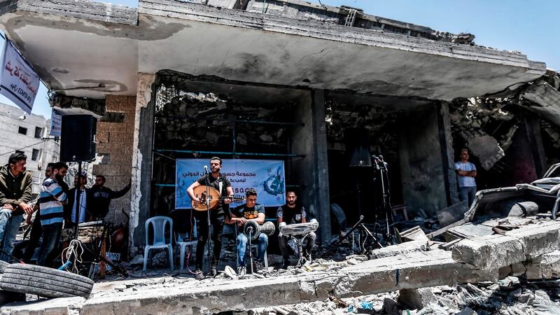 Members of the Palestinian band Dawaween perform during a musical event calling for a boycott of the Eurovision Song Contest hosted by Israel, on the rubble of a building that was recently destroyed by Israeli air strikes, in Gaza City on May 14, 2019. Photograph: Mahmud Hams/AFP/Getty Images