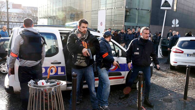 French police secure the area after a man was shot dead at a police station in the 18th district in Paris. Photograph: Philippe Wojazer/Reuters