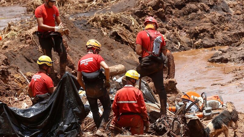 Members of a rescue team search for victims on Tuesday. Photograph: Adriano Machado/Reuters