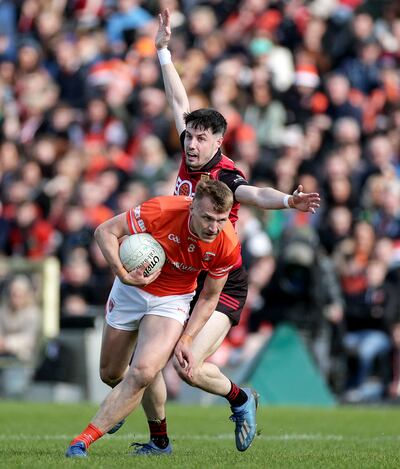 Armagh's Rian O'Neill and James Guinness of Down during Ulster  Football Championship Semi-Final. Photograph: Laszlo Geczo/Inpho