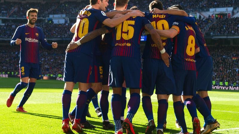 Barcelona’s Argentinian forward Lionel Messi celebrates with teammates after scoring from the penalty spot against Real Madrid. Photograph: Getty Images