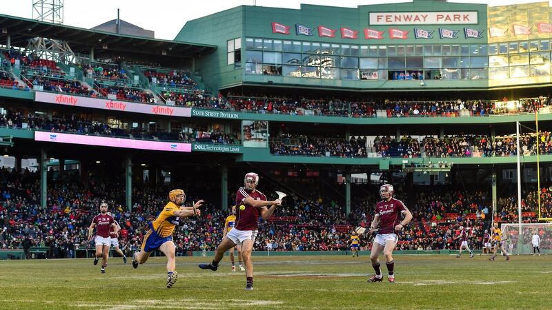 Johnny Coen of Galway has a shot on goal despite the best efforts of David McInerney of Clare to block him. Photograph: Brendan Moran/Sportsfile