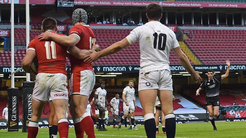 Wales’ Josh Adams is congratulated by Jonathan Davies as England’s George Ford appeals to referee Pascal Gaüzère after Adams scores their first try during the Six Nations match at the Principality Stadium in Cardiff,. Photograph: Paul Ellis/AFP via Getty Images
