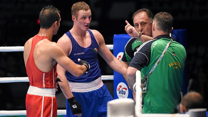Michael O’Reilly reacts alongside coaches Zaur Antia and Billy Walsh, right, after being beaten by Hosam Abdin. Photo: Paul Mohan/Sportsfile