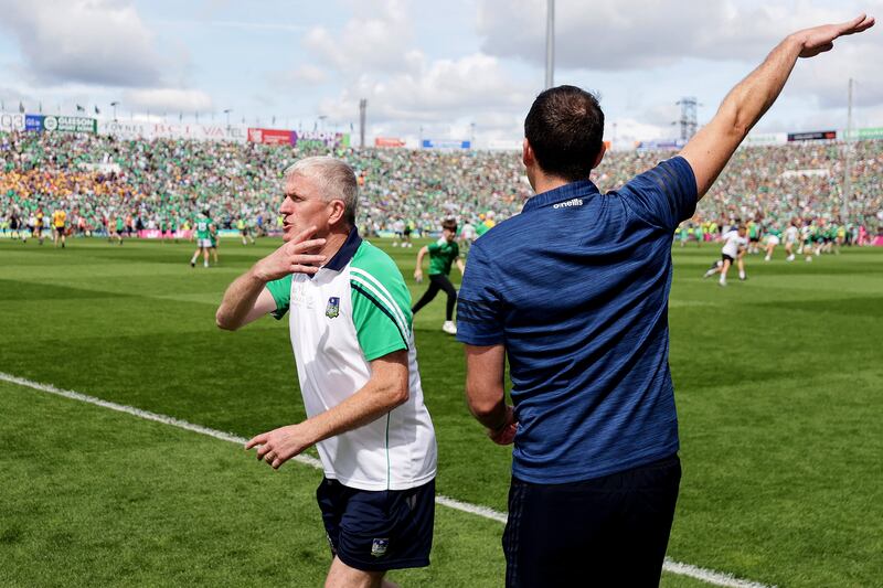 Limerick manager John Kiely joins in the attempt to clear spectators off the pitch prior to the end of the thrilling Munster final at the TUS Gaelic Grounds. Photograph: Laszlo Geczo/Inpho