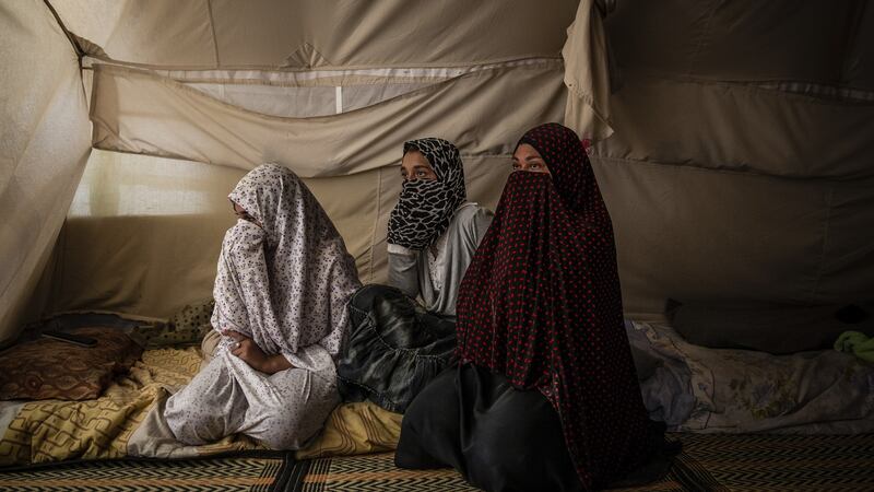 An Egyptian woman and two daughters in their tent, at Roj Camp for the families of Islamic State members in Kurdish-controlled northern Syria.  Photograph: Ivor Prickett/The New York Times