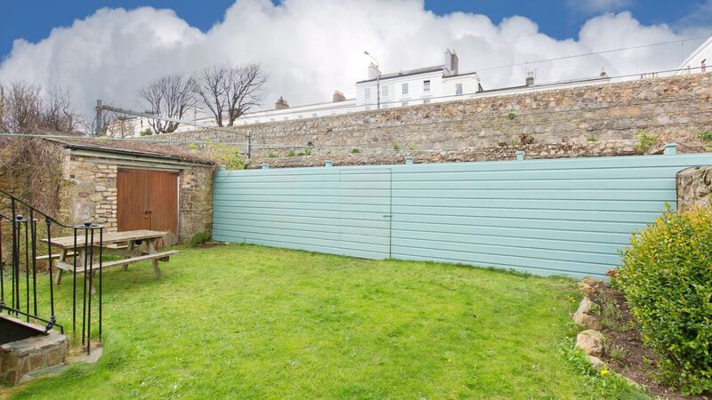 Out in the garden, there’s a little patio, perfectly positioned for reading the papers in the sunshine