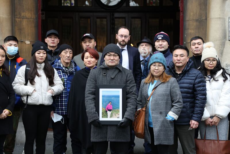 Ulambayar Surenkhor holds a photograph of his late wife Urantsetseg Tserendorj  at an anniversary Mass which was held in St Kevins Church, Harrington Street, Dublin, in January last year. The Mass was in memory of Ms Tserendorj, who was fatally stabbed in the capital in 2021. Photograph: Nick Bradshaw