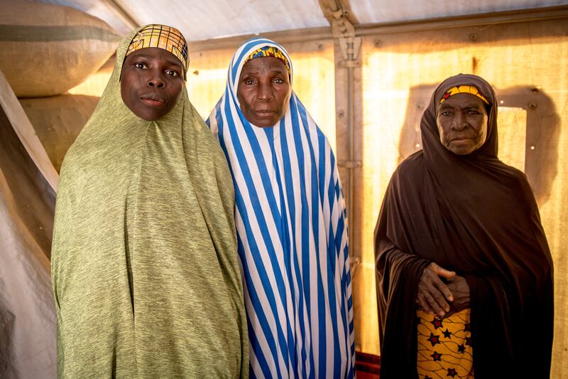 Aicha Mahaman (centre) fled to Niger with her son and two grandsons after her husband was killed by bandits. She is pictured with two friends who also escaped Nigeria. Photograph: Sally Hayden