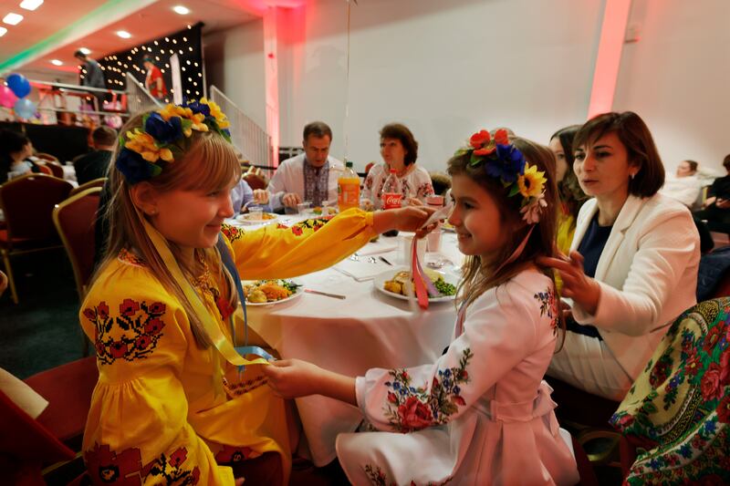 Sofia Callan and Diana Barasymovych, members of the Association of Ukrainians in Republic of Ireland folk choir after performing traditional Ukrainian Christmas carols at the Knights of Columbanus homeless dinner in the RDS. Photograph: Alan Betson 
