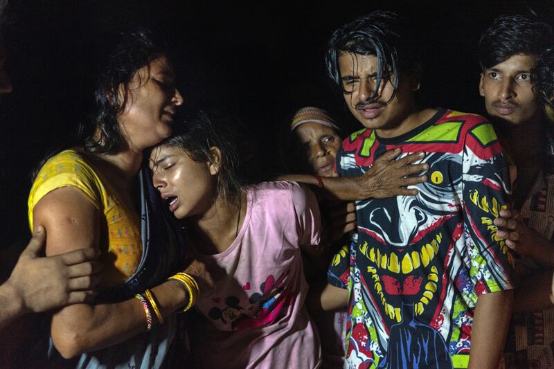 Members of Rakesh Kumar Yadav’s family mourn at his funeral in Dhamaura, Nepal, on April 13th, 2022. From left: his wife, Renu Devi Yadav; his daughter, Anisha; and a son, Ram Bishwas. Photograph: Saumya Khandelwal/New York Times