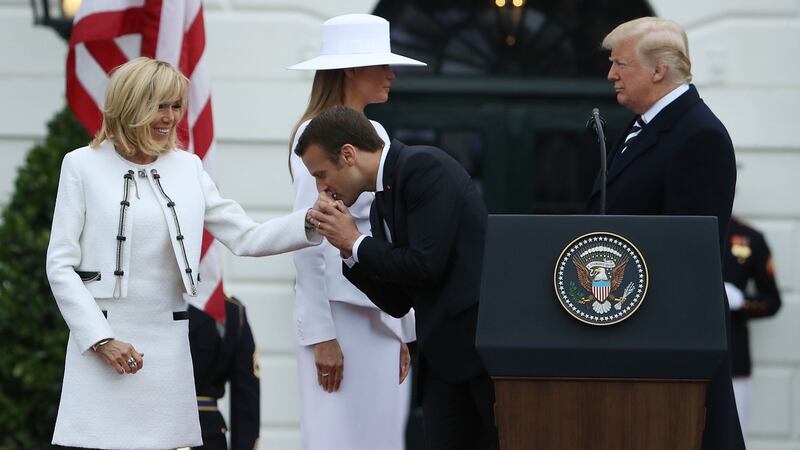 French president Emmanuel Macron kisses the hand of his wife, French first lady Brigitte Macron, as they are welcomed by US President Donald Trump and US first lady Melania Trump  at the White House. Photograph: Mark Wilson/Getty Images