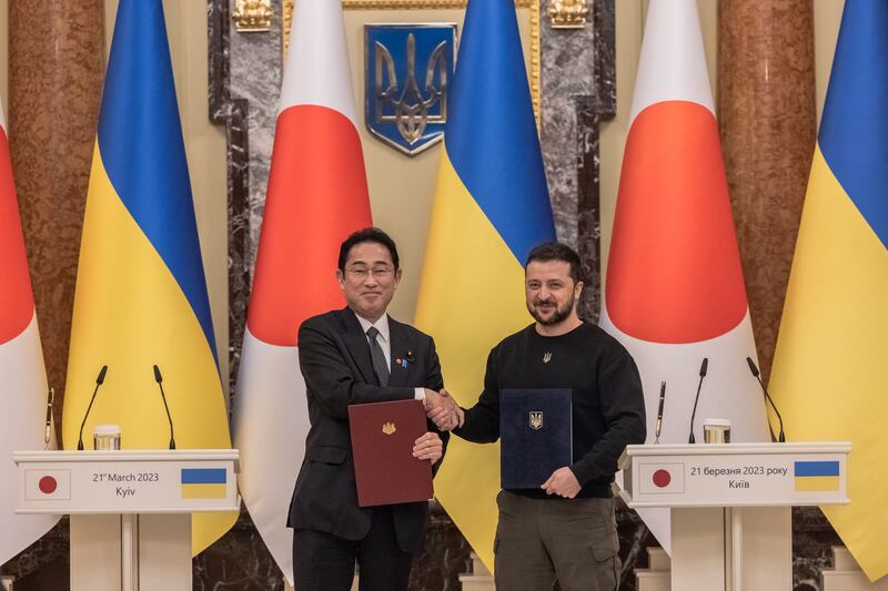 Japan's prime minister Fumio Kishida and Ukraine's president Volodymyr Zelenskiy hold signed documents during their joint press conference in Kyiv on Tuesday. Photograph: Roman Pilipey/Getty Images