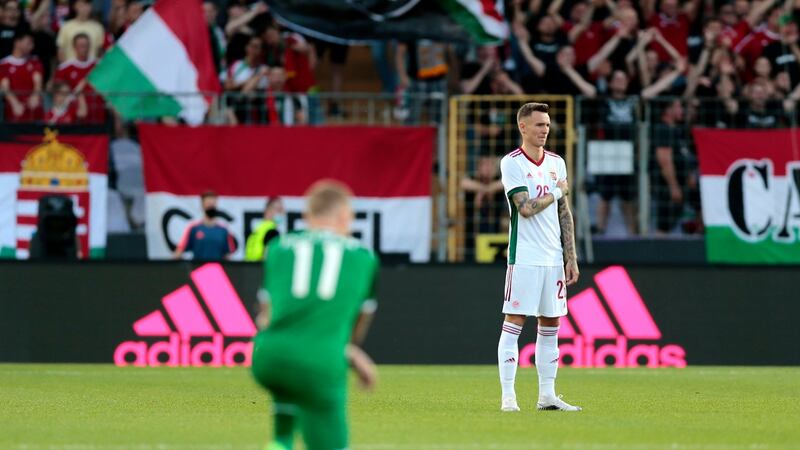 Hungary’s Bendeguz Bolla stands while Ireland’s James McClean takes a knee prior to the match at the at Szusza Ferenc Stadium in Budapest. Photograph: Trenka Atilla/PA Wire