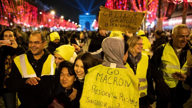 A yellow vests protester’s vest reads, “Go Macron, President of the Rich, Bleeder of the Poor” on New Years Eve in Paris. Photograph: EPA
