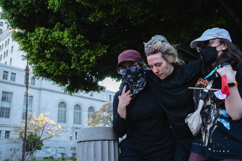 An injured protester is carried away from clashes in Los Angeles. Photograph: Jim Vondruska/Getty Images