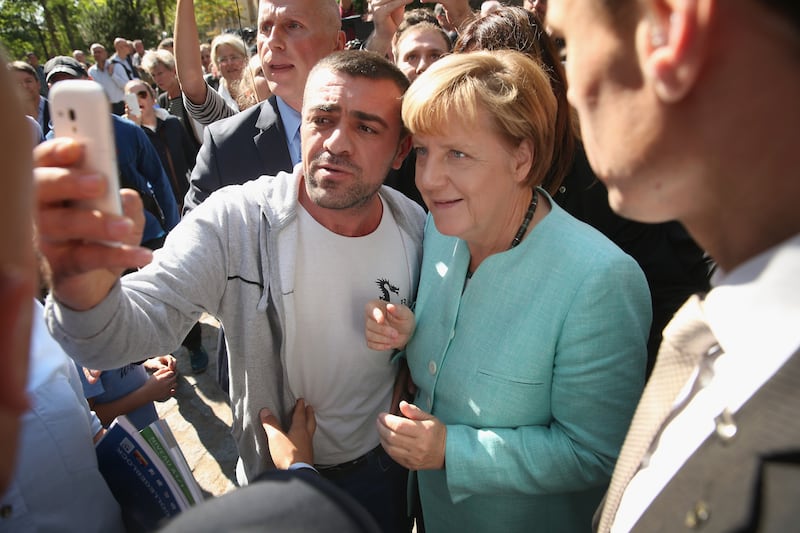 Wir schaffen das: Angela Merkel poses for a selfie with an asylum seeker in 2015. Photograph: Sean Gallup/Getty