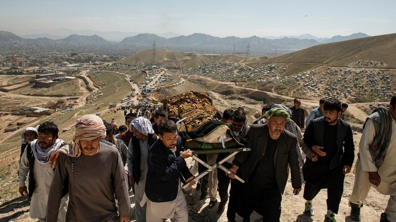Mourners at a funeral on May 9th fora girl killed in explosions outside a high school in a predominantly Hazara neighborhood in Kabu. Photograph: Kiana Hayeri/New York Times