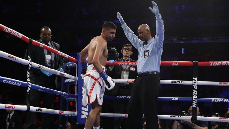 Referee David Fields stops the fight in the sixth round after Amir Khan can’t continue following a Terence Crawford low blow. Photograph: Al Bello/Getty