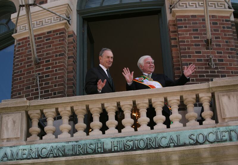 Former New York City mayor Michael Bloomberg (left), joins Dr Kevin Cahill on the balcony of the Fifth Avenue mansion after marching in the 2011 St Patrick's Day Parade. Photograph: Michael Appleton/The New York Times