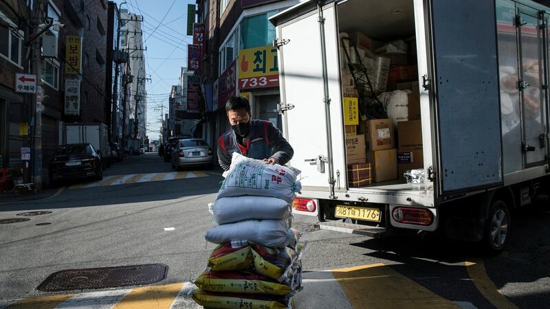 Park Ki-Ryeon  delivers bags of rice to customers in Seongnam, a city on the outskirts of Seoul.  Photograph: Woohae Cho/The New York Times