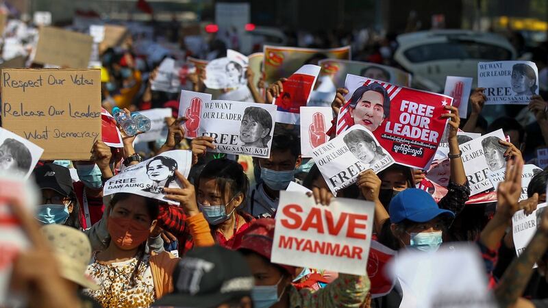 Demonstrators display placards calling for the release of Aung San Suu Kyi in Yangon on Tuesday. Photograph:  AP