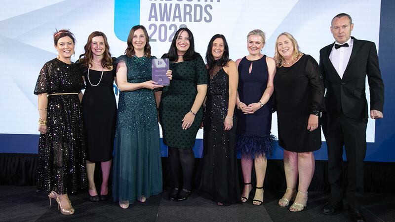 Judith Moffett, Director, CPL Resources, presents the HR Achievement Award to the NIBRT team.