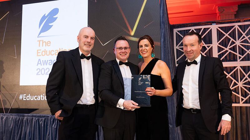 Eoin McCarthy, awards judge, presents the overall excellence award to the University of Limerick team