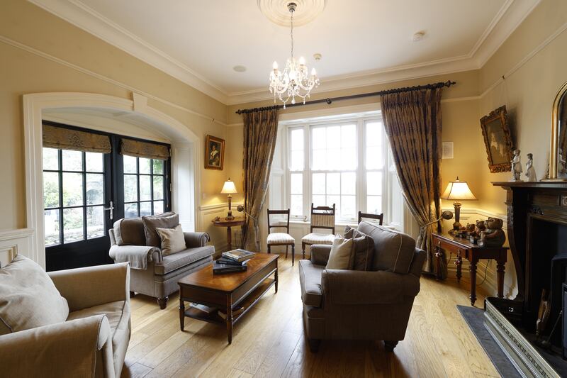 The dual aspect drawing room with an open fire. 