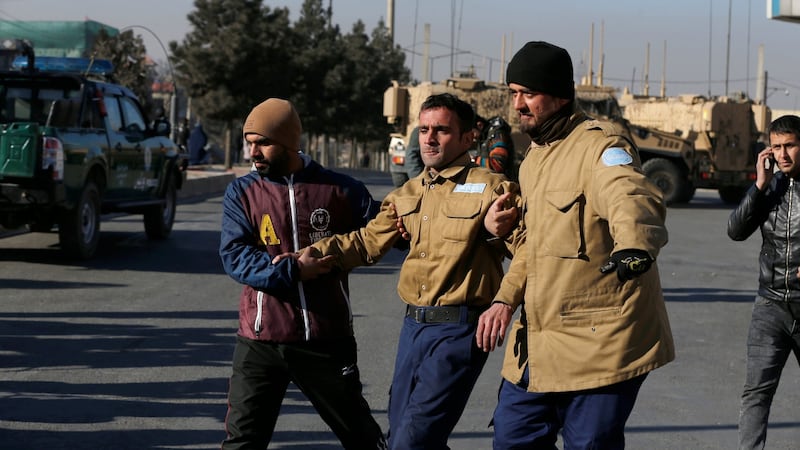 A wounded security guard receives help after being rescued from Kabul’s Intercontinental Hotel during an attack by gunmen. Photograph: Omar Sobhani/Reuters