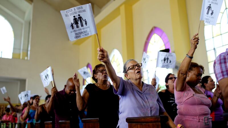 Worshippers wave paper flags that read in Spanish “I am in favour of the original design. The family as God created it. Wedding between man and woman”, during a service at a Methodist Church in Havana, Cuba, in October 2018. File photograph: Alexandre Meneghini/Reuters
