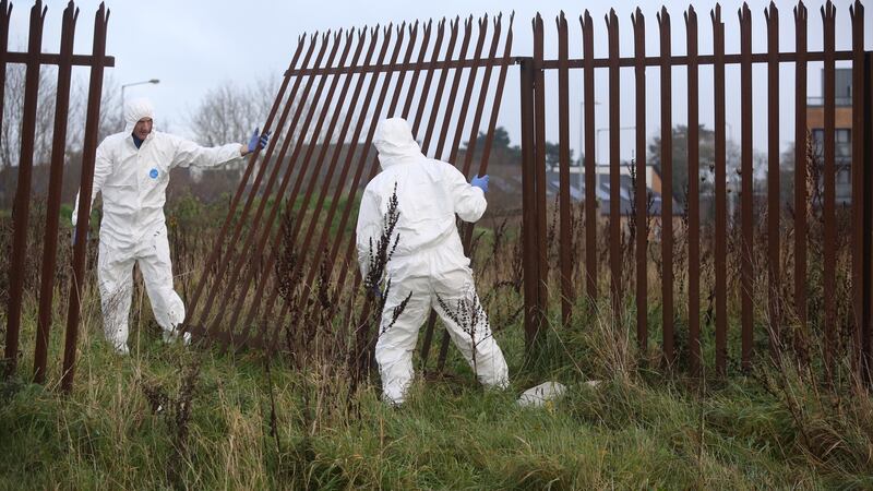 Garda forensic experts at the scene in Ballymun where the body was found.  Photograph: Collins