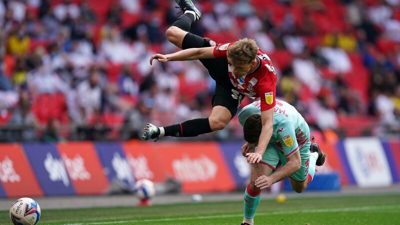 Mads Roerslev clashes with Ryan Manning. Photo: Mike Egerton/PA Wire
