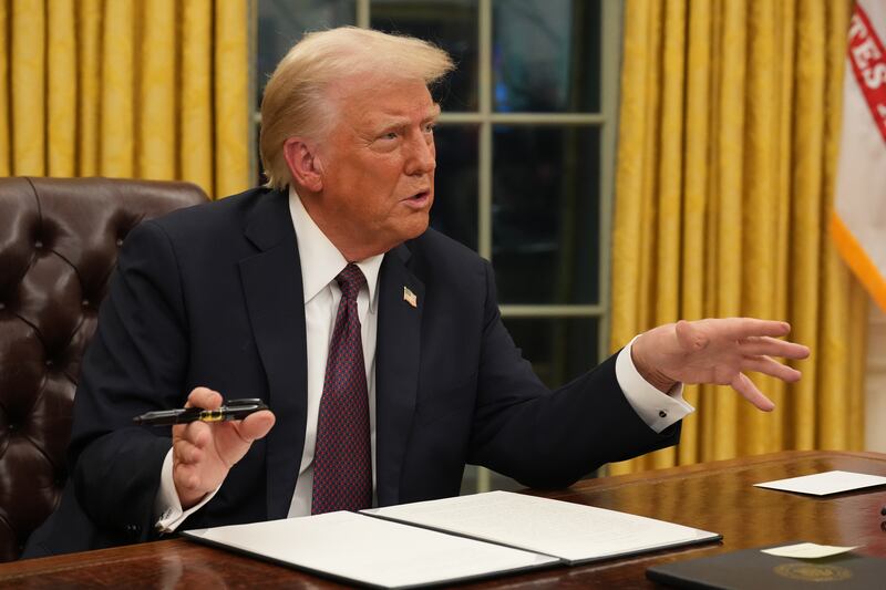 US president Donald Trump signs executive orders in the Oval Office of the White House. Photograph: Doug Mills/New York Times