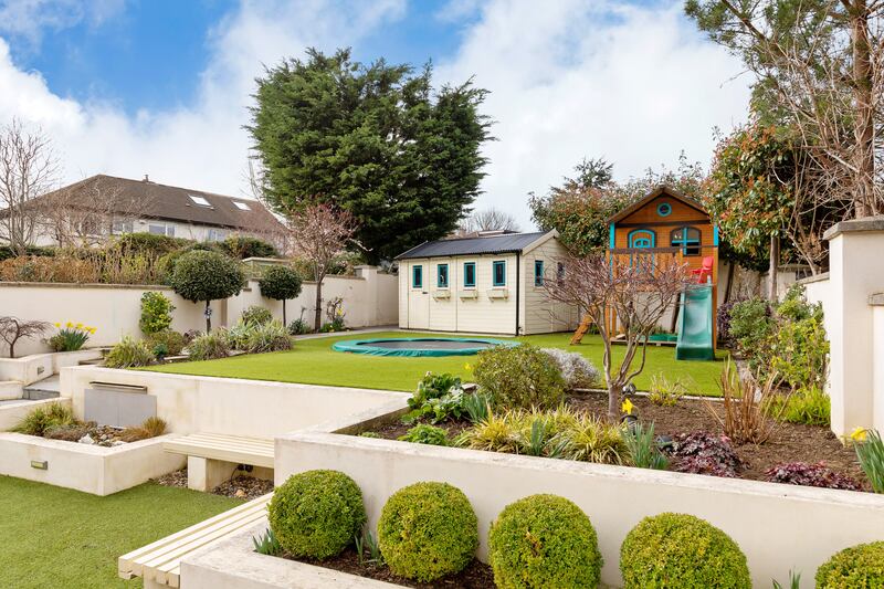The rear garden accommodates the needs of children and adults