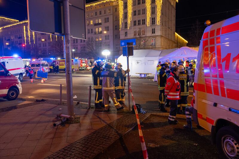Police vans and ambulances respond next to the scene of the incident. Photograph: Craig Stennett/Getty