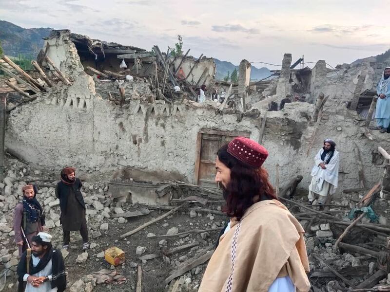 Afghans look at destruction caused by an earthquake in the province of Paktika, eastern Afghanistan 