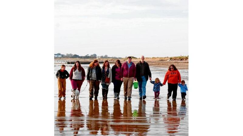 Janet Howley, (right to left) with grandchild Jonah, Elijah, husband Eugene, son Johnathan, his partner Louanne, children Bronwyn, Benjamin, Sophie , Isaac and dog AlliePic. photograph: michael mac sweeney/provision